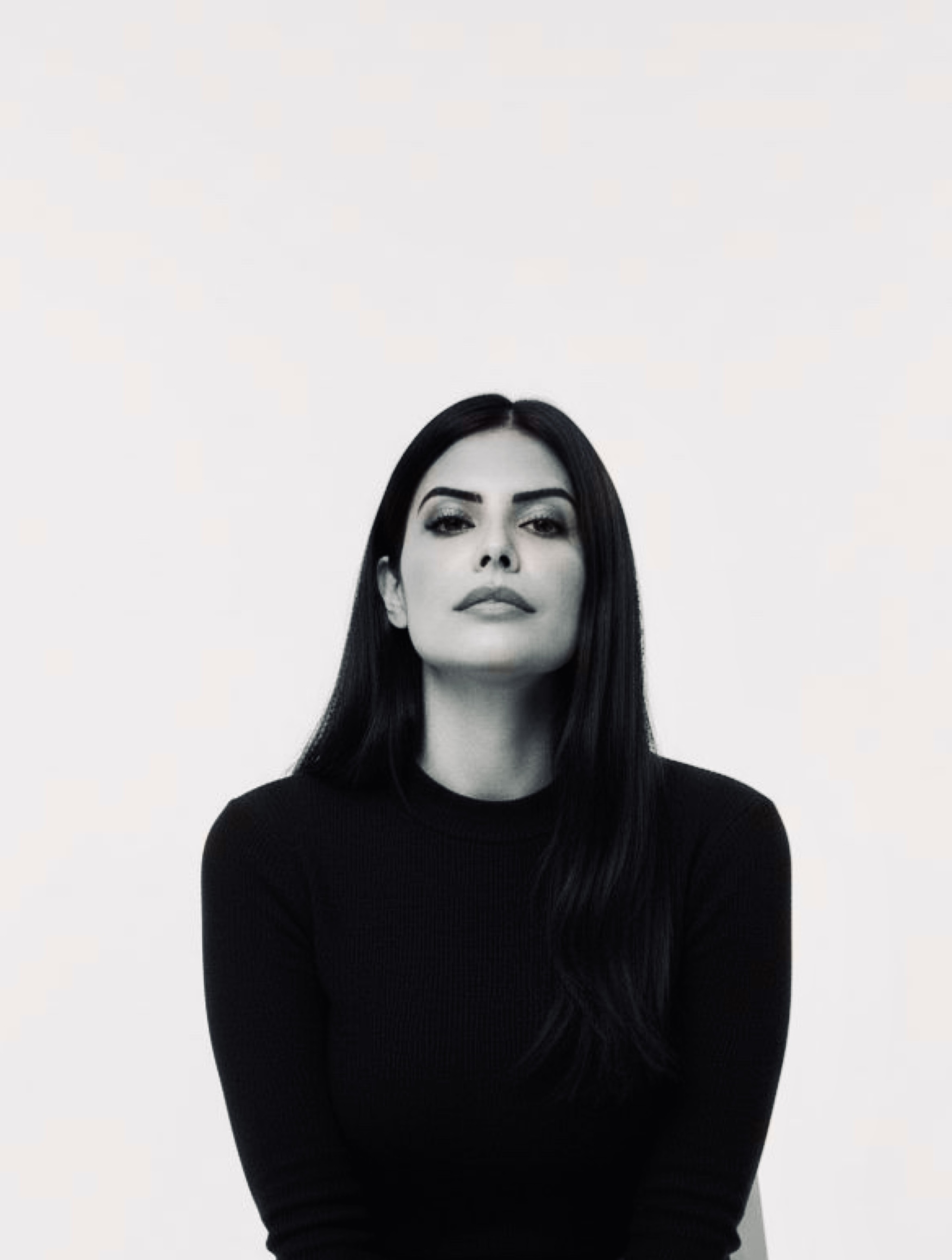Portrait of Bahar Keshavarz sitting outdoors against a rocky texture background